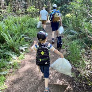 Participants in the Galiano BioBlitz remove garbage from Qw'xwulwis (Cable Bay), Galiano.