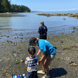 Swim Drink Fish staff encourage 5 year-old community participant Cowan to help sample water at the Galiano BioBlitz 2023.