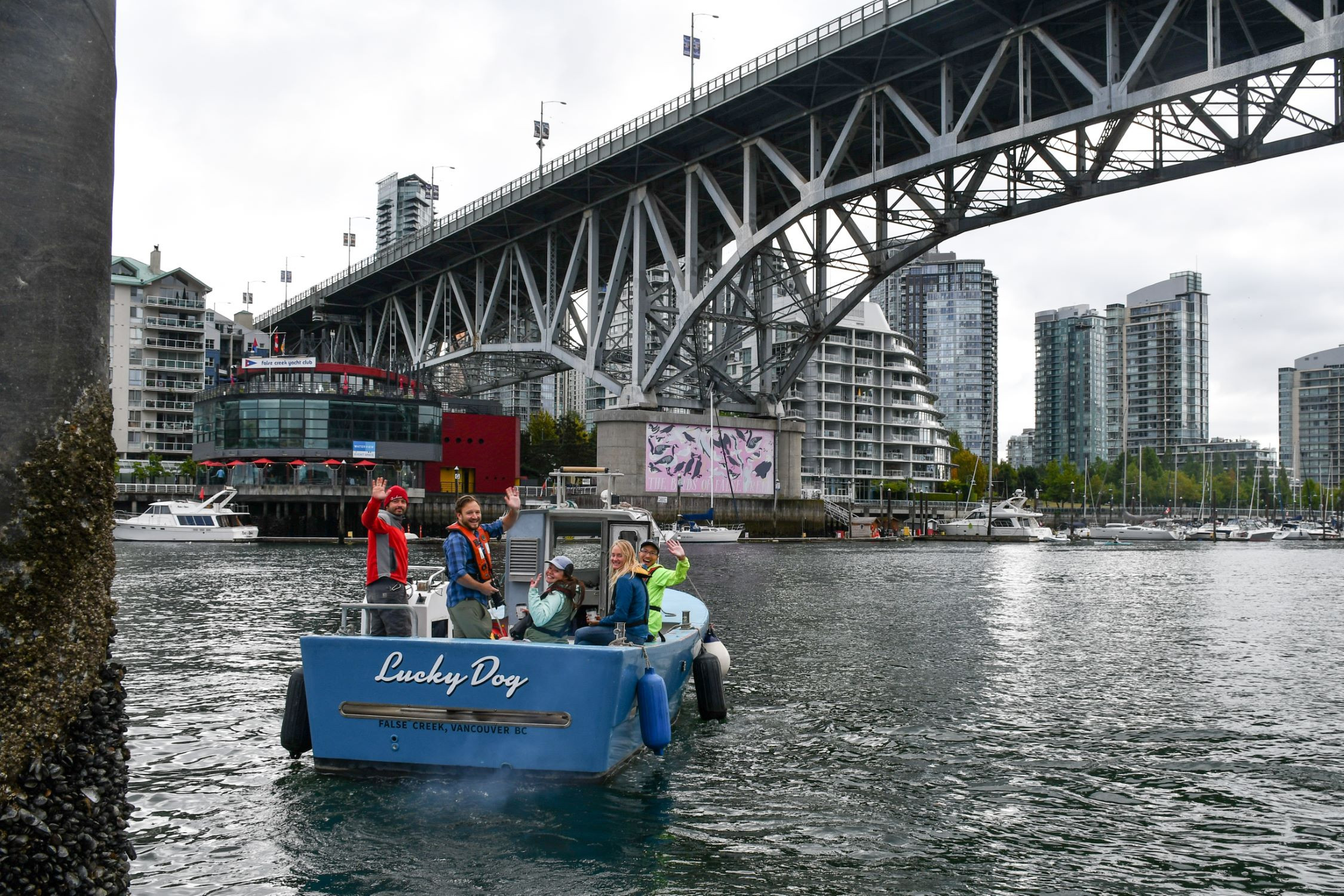 Participants in the False Creek BioBlitz wave from the vessel 'Lucky Dog'.