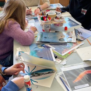 Can you spot the squid? Students use collage to create art inspired by Hakai Institute photos while artists/scientist Romney McPhie demonstrates.